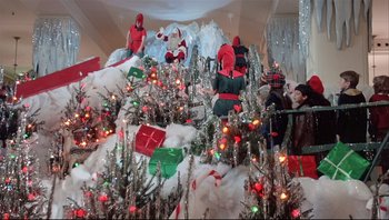 Movie still from “A Christmas Story” (1983), directed by Bob Clark – A group of people standing next to christmas trees; Extreme Wide shot, Low angle