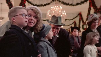 Movie still from “A Christmas Story” (1983), directed by Bob Clark – A group of people standing in front of a christmas tree; Medium shot, Low angle