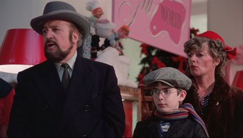 Movie still from “A Christmas Story” (1983), directed by Bob Clark – A man and a boy wearing hats and glasses; Medium shot, Low angle