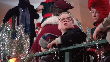 Movie still from “A Christmas Story” (1983), directed by Bob Clark – A young boy wearing glasses and a red hat; Close Up shot, Low angle
