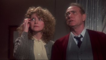 Movie still from “A Christmas Story” (1983), directed by Bob Clark – A man and a woman standing next to each other; Medium shot, Low angle