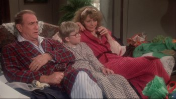Movie still from “A Christmas Story” (1983), directed by Bob Clark – A woman and a boy sitting on a couch; Medium shot, High angle