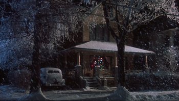 Movie still from “A Christmas Story” (1983), directed by Bob Clark – A car parked in front of a house in the snow; Extreme Wide shot, Low angle