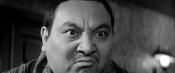 Movie still from “A Colt Is My Passport” (1967), directed by Takashi Nomura – Black and white photograph of a man making an angry face; Close Up shot, Low angle