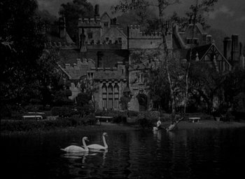 Movie still from “A Damsel in Distress” (1937), directed by George Stevens – Two swans swimming on a lake in front of a castle; Extreme Wide shot, High angle