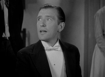 Movie still from “A Damsel in Distress” (1937), directed by George Stevens – A black and white photo of a man in a tuxedo; Close Up shot, Low angle