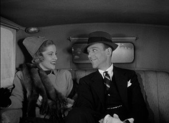 Movie still from “A Damsel in Distress” (1937), directed by George Stevens – A man and a woman sitting in the back of a car; Medium shot, Low angle