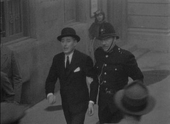 Movie still from “A Damsel in Distress” (1937), directed by George Stevens – Two men in suits and hats are walking down the street; Medium shot, High angle