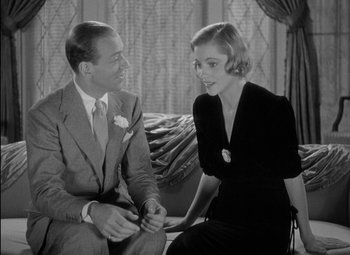 Movie still from “A Damsel in Distress” (1937), directed by George Stevens – A man and a woman sitting next to each other on a couch; Medium shot, High angle