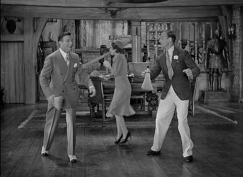 Movie still from “A Damsel in Distress” (1937), directed by George Stevens – A black and white photo of people dancing in a living room; Wide shot, High angle