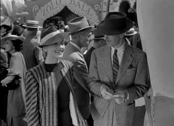 Movie still from “A Damsel in Distress” (1937), directed by George Stevens – A man and a woman are standing in a crowd of people; Medium shot, High angle