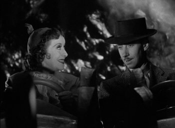 Movie still from “A Damsel in Distress” (1937), directed by George Stevens – A man and a woman are sitting in a car together; Close Up shot, High angle