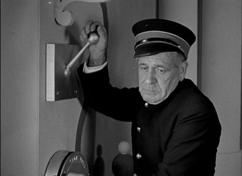 Movie still from “A Damsel in Distress” (1937), directed by George Stevens – An old man in a uniform is holding a pole; Medium shot, Low angle