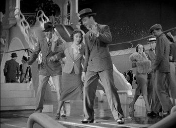 Movie still from “A Damsel in Distress” (1937), directed by George Stevens – A group of men and women dancing on a stage; Wide shot, High angle