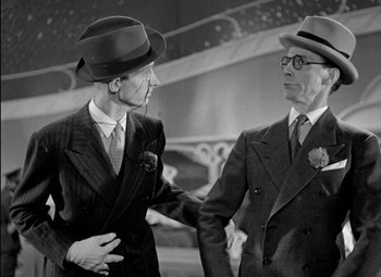 Movie still from “A Damsel in Distress” (1937), directed by George Stevens – A man and a man in a suit and tie; Medium shot, Low angle