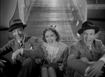 Movie still from “A Damsel in Distress” (1937), directed by George Stevens – A black and white photo of a man and a woman and another man; Medium shot, High angle