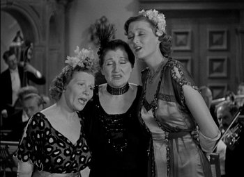Movie still from “A Damsel in Distress” (1937), directed by George Stevens – A group of women standing next to each other; Medium shot, High angle