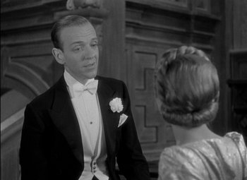 Movie still from “A Damsel in Distress” (1937), directed by George Stevens – A man and a woman in formal wear talking; Close Up shot, Over the shoulder angle