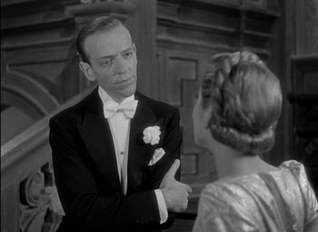 Movie still from “A Damsel in Distress” (1937), directed by George Stevens – A man and a woman in formal wear talking; Close Up shot, Over the shoulder angle