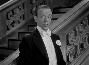 Movie still from “A Damsel in Distress” (1937), directed by George Stevens – A black and white photo of a man in a tuxedo; Close Up shot, Low angle