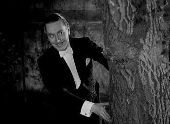 Movie still from “A Damsel in Distress” (1937), directed by George Stevens – A black and white photo of a man in a tuxedo; Medium shot, Low angle