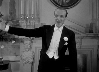Movie still from “A Damsel in Distress” (1937), directed by George Stevens – A man in a black suit and a white bow tie; Medium shot, Low angle