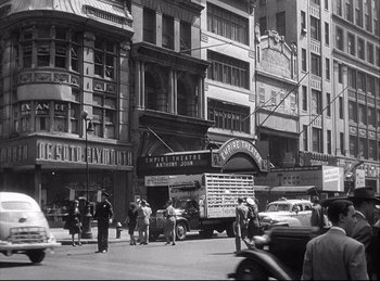 Movie still from “A Double Life” (1947), directed by George Cukor – A black and white photo of a street scene in the 1 9 4 0 s; Extreme Wide shot, High angle