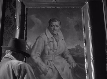 Movie still from “A Double Life” (1947), directed by George Cukor – A black and white photo of a man in a coat and hat; Close Up shot, Low angle