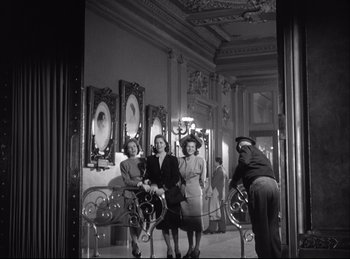 Movie still from “A Double Life” (1947), directed by George Cukor – A group of people standing in a room; Wide shot, Low angle