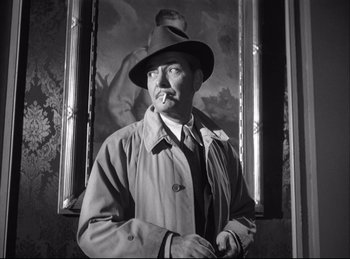 Movie still from “A Double Life” (1947), directed by George Cukor – A man wearing a hat and a trench coat; Medium shot, Low angle