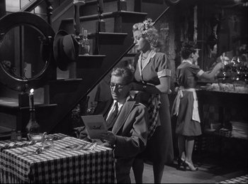 Movie still from “A Double Life” (1947), directed by George Cukor – A man and a woman are sitting at a table; Medium shot, High angle