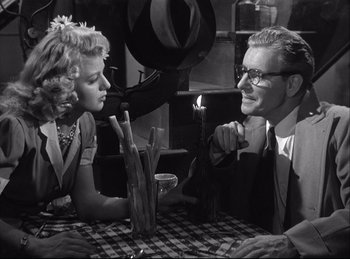Movie still from “A Double Life” (1947), directed by George Cukor – An older man and woman sitting at a dinner table; Medium shot, Over the shoulder angle