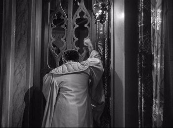 Movie still from “A Double Life” (1947), directed by George Cukor – A man in a robe is standing in front of an open door; Medium shot, Low angle
