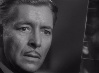 Movie still from “A Double Life” (1947), directed by George Cukor – An older man is looking at the camera; Close Up shot, Over the shoulder angle