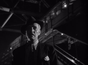 Movie still from “A Double Life” (1947), directed by George Cukor – An older man wearing a suit and a hat; Medium shot, Low angle