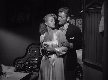 Movie still from “A Double Life” (1947), directed by George Cukor – A man and a woman standing next to each other; Medium shot, Low angle