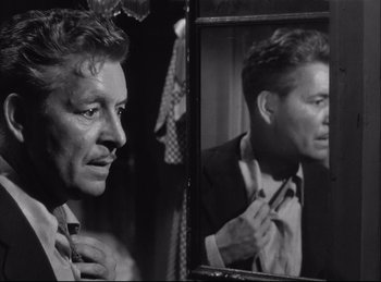 Movie still from “A Double Life” (1947), directed by George Cukor – A black and white photo of a man in a mirror; Close Up shot, Over the shoulder angle