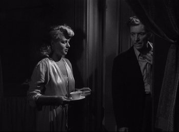 Movie still from “A Double Life” (1947), directed by George Cukor – An old photo of a man and a woman in a room; Medium shot, Over the shoulder angle