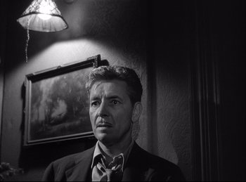 Movie still from “A Double Life” (1947), directed by George Cukor – Black and white photograph of a man in a suit and tie; Close Up shot, Low angle