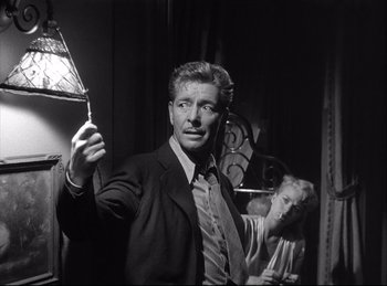 Movie still from “A Double Life” (1947), directed by George Cukor – A black and white photo of a man and woman; Medium shot, Low angle