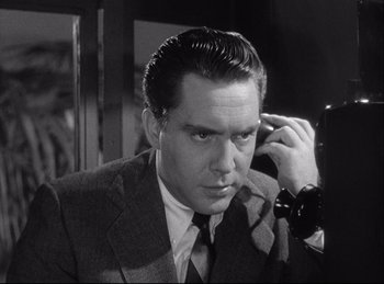 Movie still from “A Double Life” (1947), directed by George Cukor – A black and white photo of a man talking on a phone; Close Up shot, Low angle