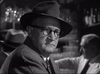Movie still from “A Double Life” (1947), directed by George Cukor – An older man wearing glasses and a hat; Close Up shot, Over the shoulder angle