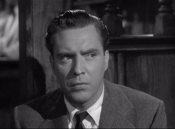 Movie still from “A Double Life” (1947), directed by George Cukor – A man in a suit and tie looking at the camera; Close Up shot, Low angle