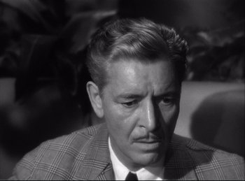 Movie still from “A Double Life” (1947), directed by George Cukor – An older man wearing a suit and tie; Close Up shot, High angle