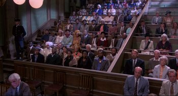 Movie still from “A Dry White Season” (1989), directed by Euzhan Palcy – A group of people sitting in a large auditorium; Wide shot, High angle