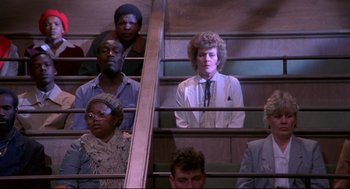 Movie still from “A Dry White Season” (1989), directed by Euzhan Palcy – A group of people that are sitting on some stairs; Medium shot, High angle