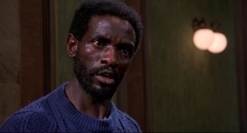 Movie still from “A Dry White Season” (1989), directed by Euzhan Palcy – A person wearing a sweater; Close Up shot, High angle