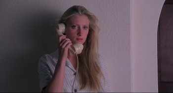 Movie still from “A Dry White Season” (1989), directed by Euzhan Palcy – A woman holding a phone up to her ear; Close Up shot, Low angle