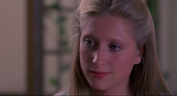 Movie still from “A Dry White Season” (1989), directed by Euzhan Palcy – A person with long blonde hair; Close Up shot, Over the shoulder angle