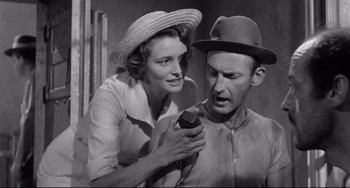 Movie still from “A Face in the Crowd” (1957), directed by Elia Kazan – An old black and white photo of a man and a woman; Medium shot, Low angle